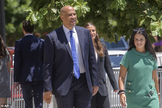 Sen. Cory Booker, D-N.J., came out to hand out bottles of water to reporters but declined to answer questions from reporters about the private event.