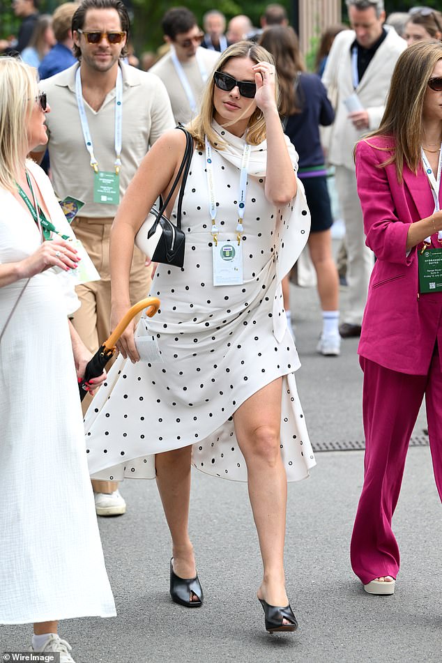 The 34-year-old actress looked maternity chic in a polka dot dress as she gingerly held onto her baby bump as she walked hand-in-hand with Tom.