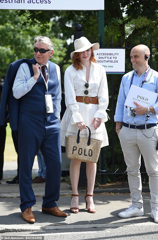 Eleanor Tomlinson looked effortlessly chic in a white dress and wicker bag.