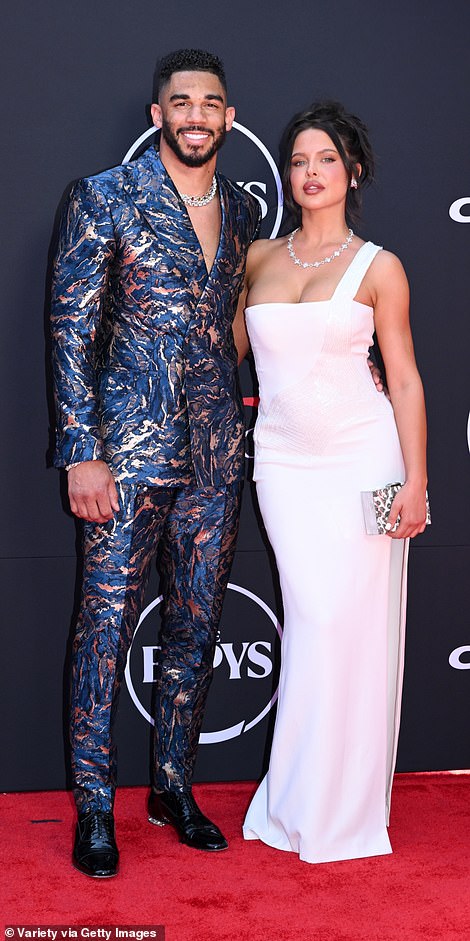 Evander Kane also preferred blue, but his silver-flecked suit was the difference between camouflage and oil spill; seen with Mara Teigen