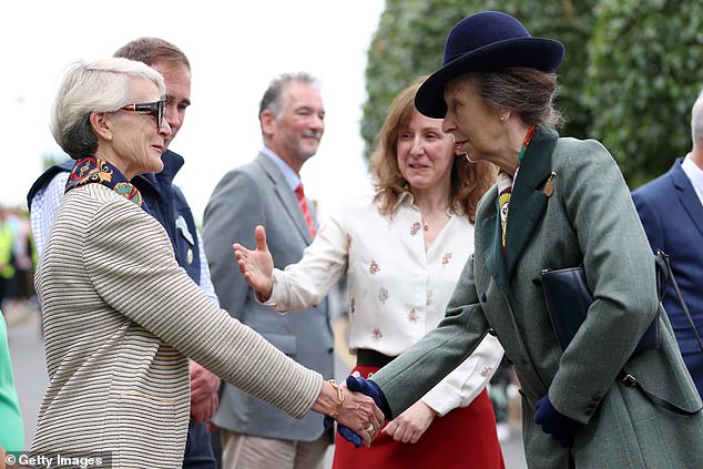 Princess Anne is pictured shaking hands with guests as she attended an event at the Riding for the Disabled Association (RDA) National Championships on Friday afternoon.