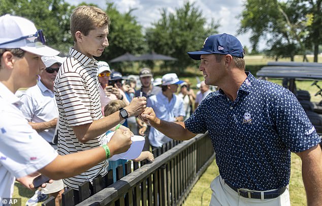 Bryson DeChambeau of Crushers GC greets a fan during the first round of LIV Golf Nashville