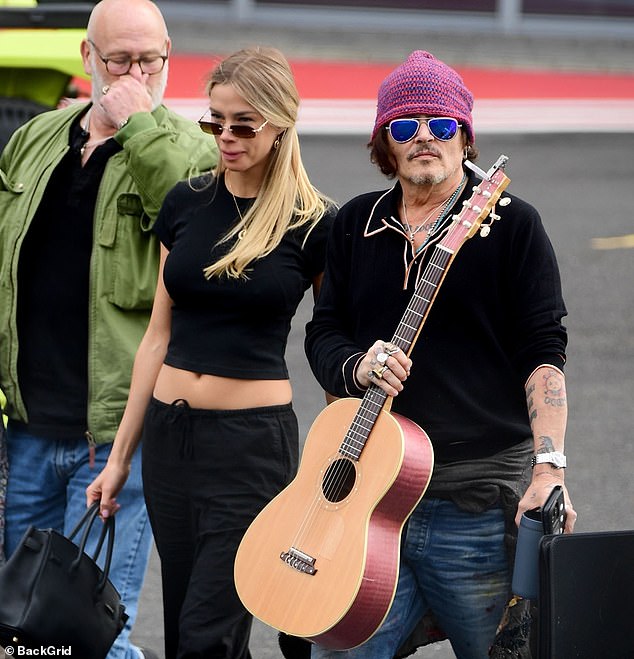 The unidentified companion matched her style, sporting a casual yet chic all-black outfit, baring her midriff and clutching a handbag, accessorized with rectangular-framed sunglasses.