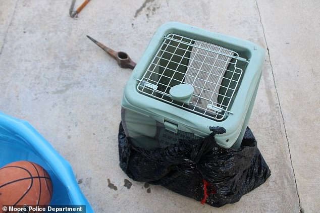 The pet carrier and the garbage bag the animal was placed in.