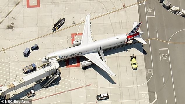 An aerial photo shows the American Airlines Airbus after it was evacuated at San Francisco International Airport with its emergency escape chutes deployed.