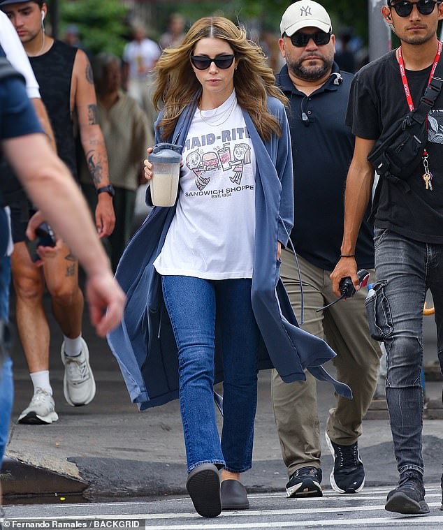 Jessica donned black sandals and black sunglasses as she finished filming and carried a milkshake in one hand as she crossed the street in the Big Apple.