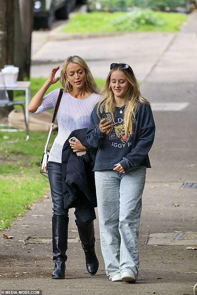 Jackie wore a sheer white sweater with a striped detail, and her black bra peeked out from underneath.