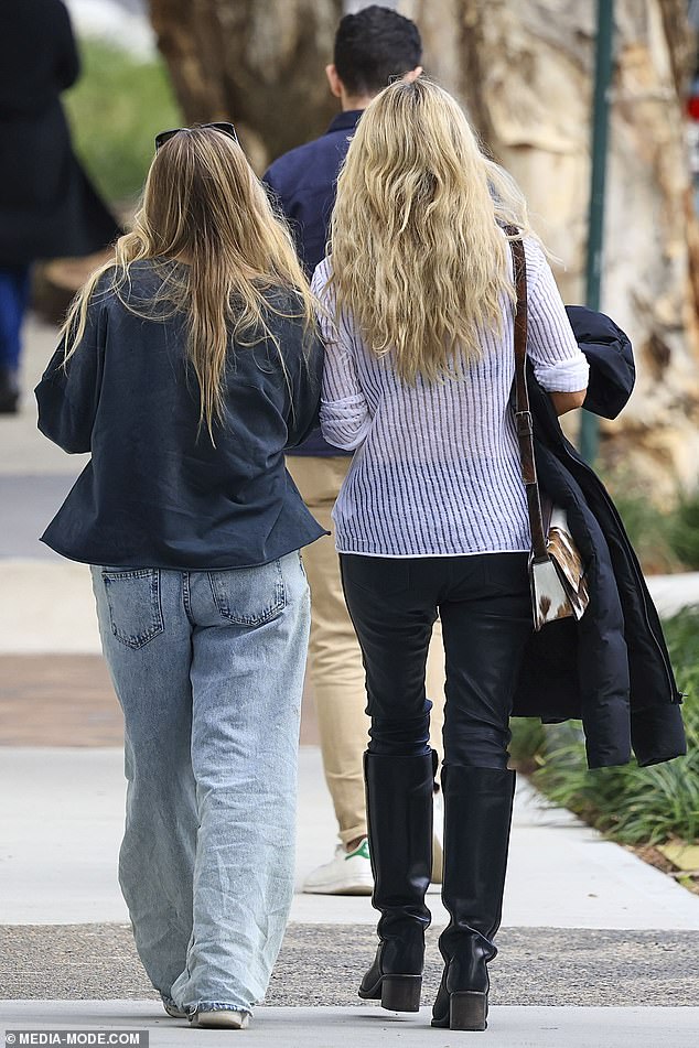 Kitty, 13, kept things casual in a pair of wide-leg jeans and a printed jumper.