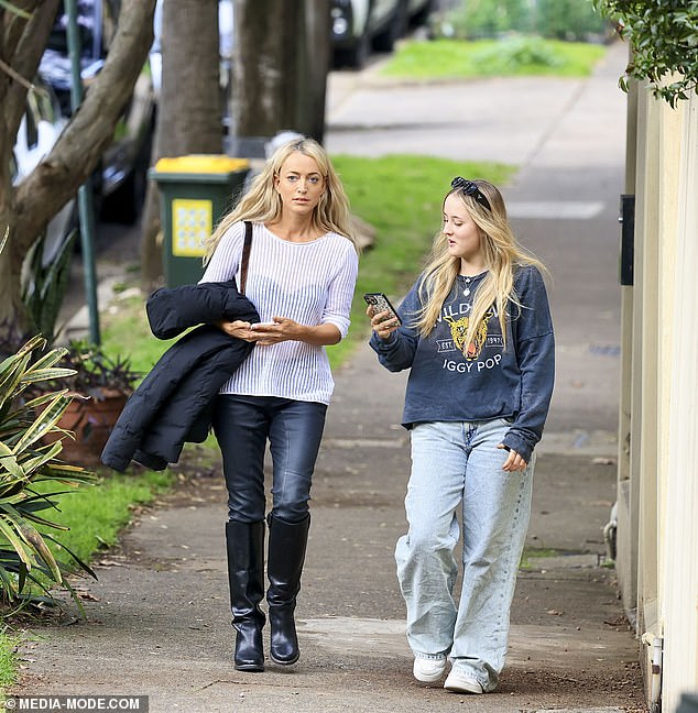 The media personality wore a black quilted jacket over her arm and carried a designer shoulder bag.