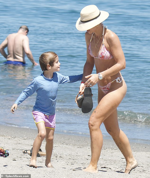 After spending some time in the water, Vogue was spotted walking along the beach with her eldest son Theodore.