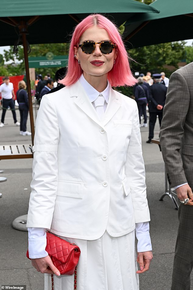 Lucy Boynton showed off her bright pink hair and dressed in a white suit for the outing.