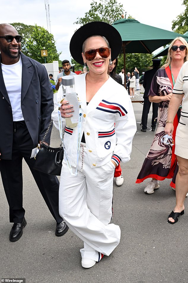 Pink looked chic in a white Gucci jacket and matching pants.