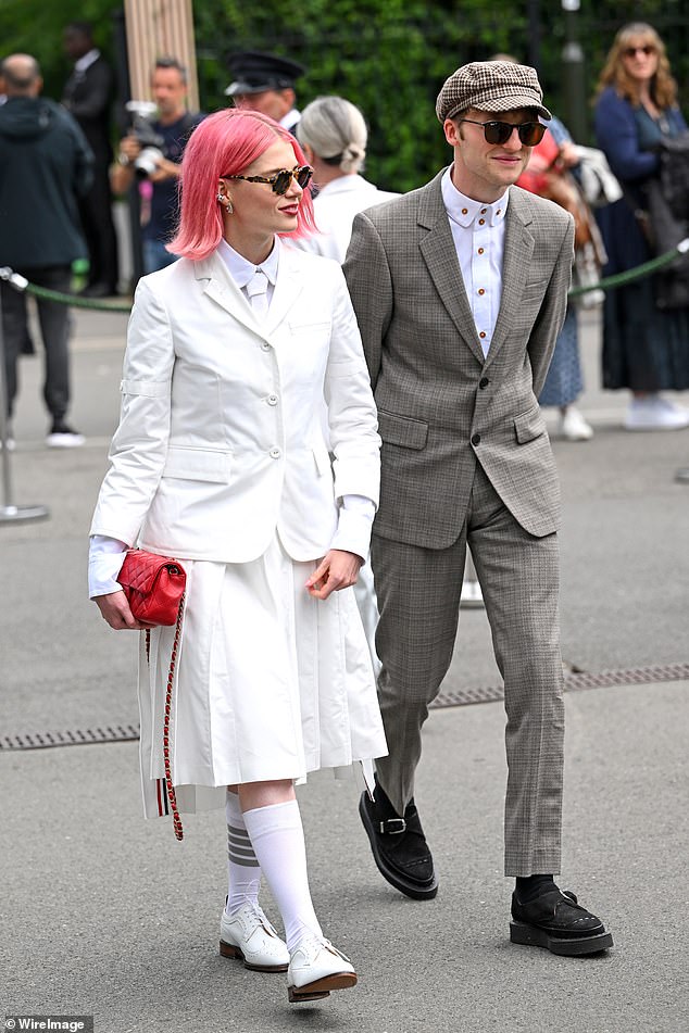 Lucy smiled and posed gracefully alongside her musician boyfriend Murdo before the game, with the pair looking relaxed chatting and laughing with each other.