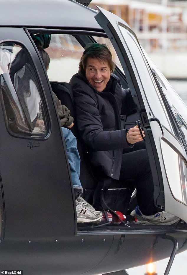 Tom was all smiles as he opened the helicopter door after landing.