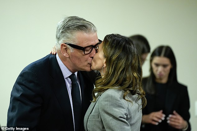 Baldwin and his wife kiss and hug as the actor was able to walk out of court a free man.