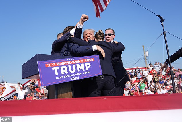 US Secret Service escorts Trump off stage after shots fired at him