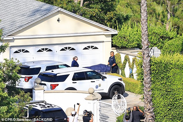 Several police vehicles were at the entrance following the death of the fitness guru.