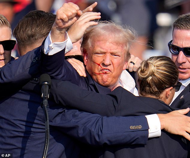 Trump remained defiant after the attack, vigorously shaking his fist at the crowd.