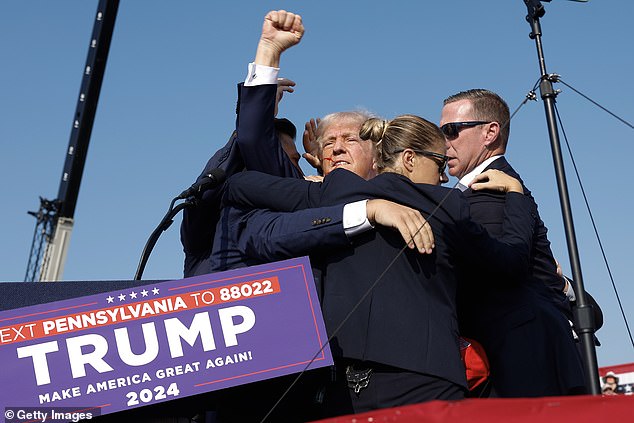 The US Secret Service swooped on Trump before he rose to his feet in a show of defiance that was captured in a photo seen around the world.