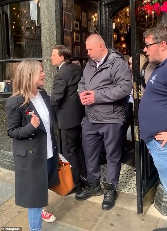 The woman points to the Palestinian flag on her jacket and has an argument with the staff member.