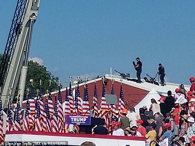 Snipers stand on a rooftop during Republican presidential candidate and former US President Donald Trump's campaign rally in Butler, Pennsylvania