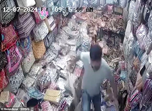 As the man walks away, CCTV footage shows the fabric store in ruins.