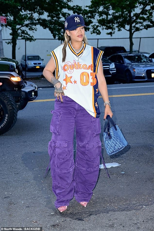 The 36-year-old Barbadian billionaire wore a New York Yankees cap over her blonde wig, a T-shirt from six-time Grammy-winning rap duo Outkast, purple denim cargo pants and pink reptile heels.