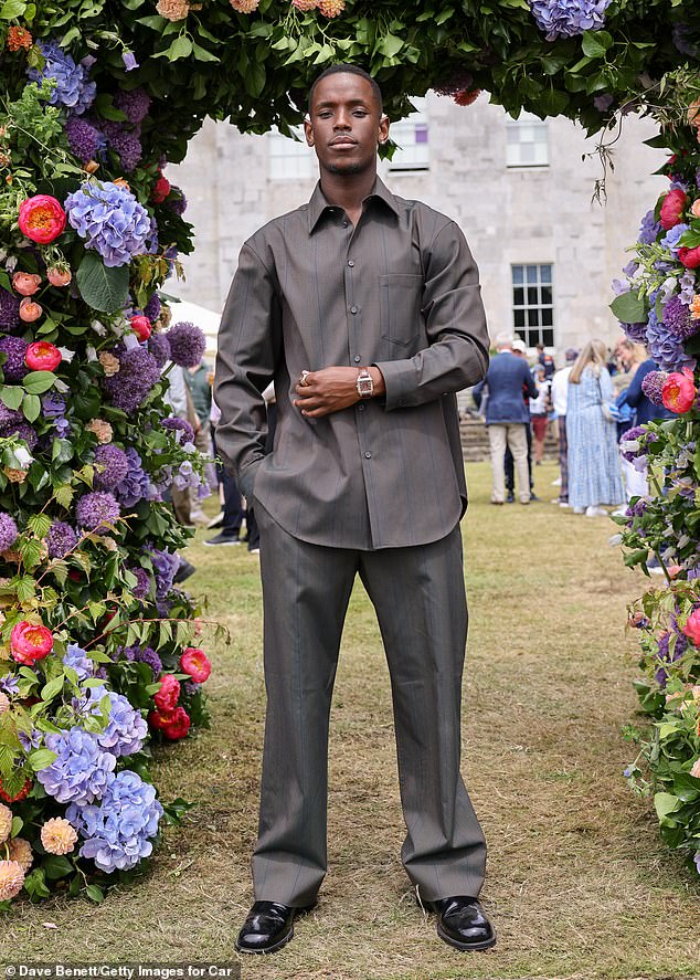 The actor put on a dapper display in a sleek grey suit and polished black shoes.