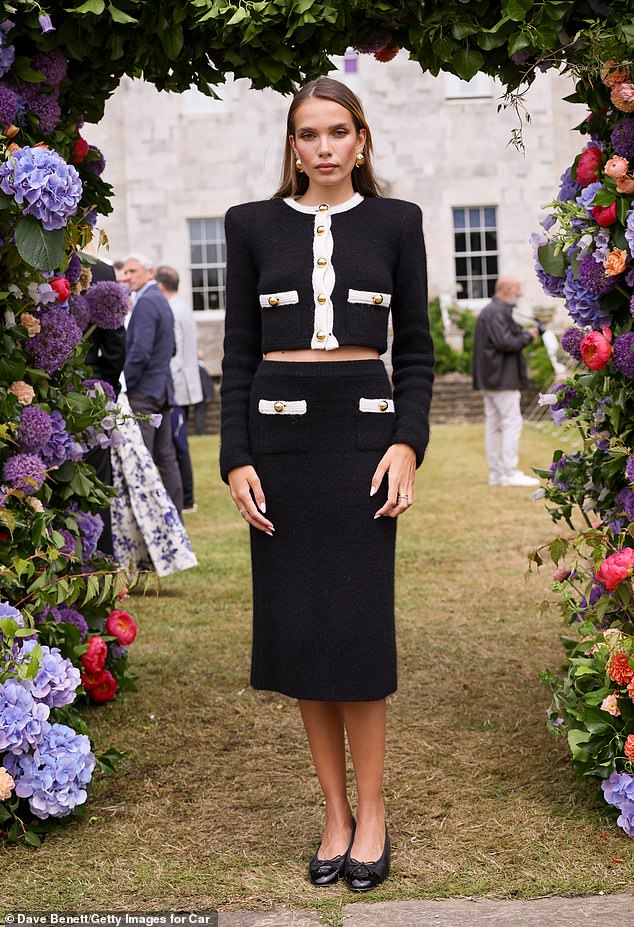 Hana Cross looked effortlessly chic in a Chanel-inspired look, slipping into a black and white suit.