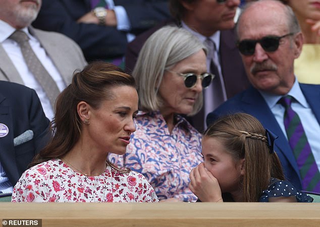 At one point during the match, Charlotte was photographed whispering happily to her aunt and covering her mouth with one hand.