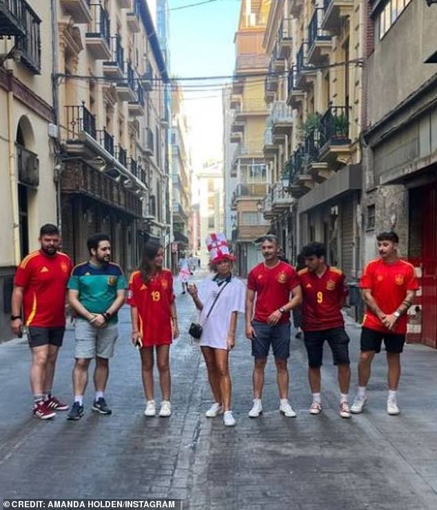 At one point in the video, Amanda jumps alongside Spanish supporters outside a picturesque street in Europe.