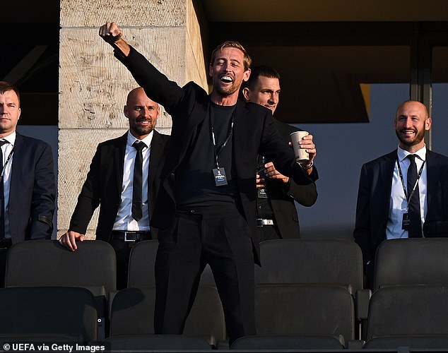 Martin and Roman led the stars into the match alongside former footballer Peter Crouch (pictured), who held his arms high as he waited patiently for kick-off.