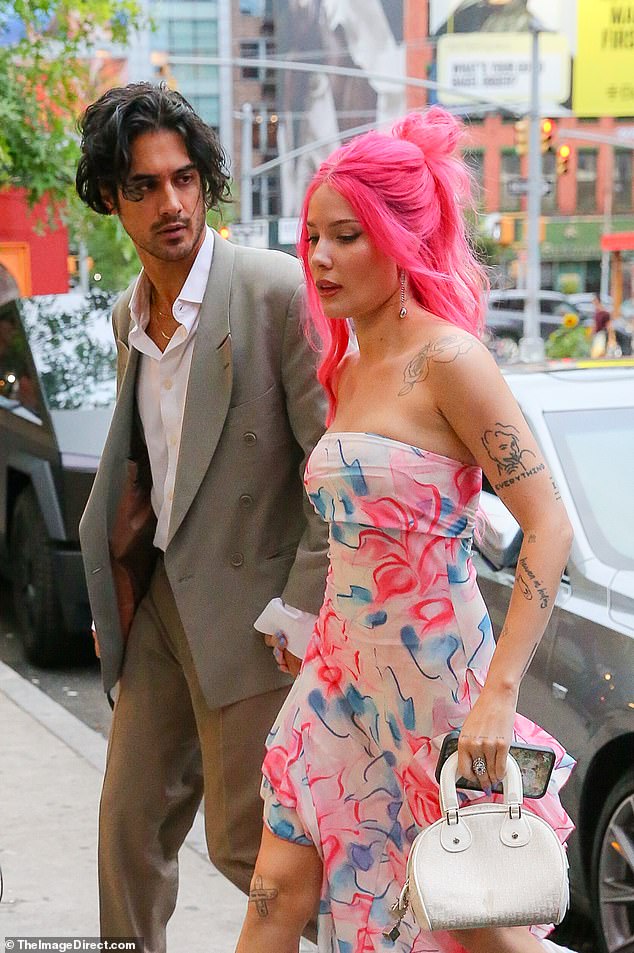 With her vibrant hot pink hair, the Maxxxine star looked every bit the fashionista, perfectly coordinating the neon hue with a bright floral dress.