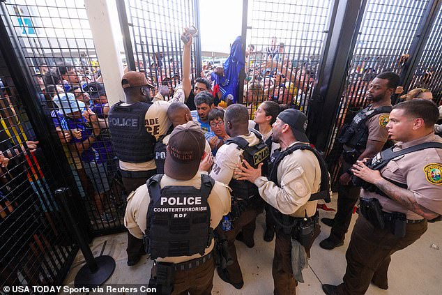 Police are seen allowing some Argentine fans to enter while other spectators wait to enter.