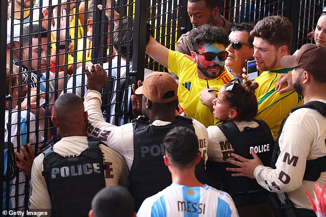 Fans try to enter the stadium amid riots ahead of the CONMEBOL Copa America final