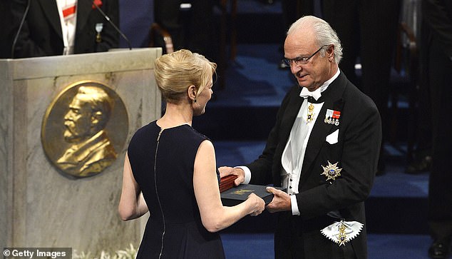 Nobel Prize winner in Literature Alice Munro, represented by her daughter Jenny Munro (left), receives her Nobel Prize from King Carl XVI Gustaf of Sweden in 2013