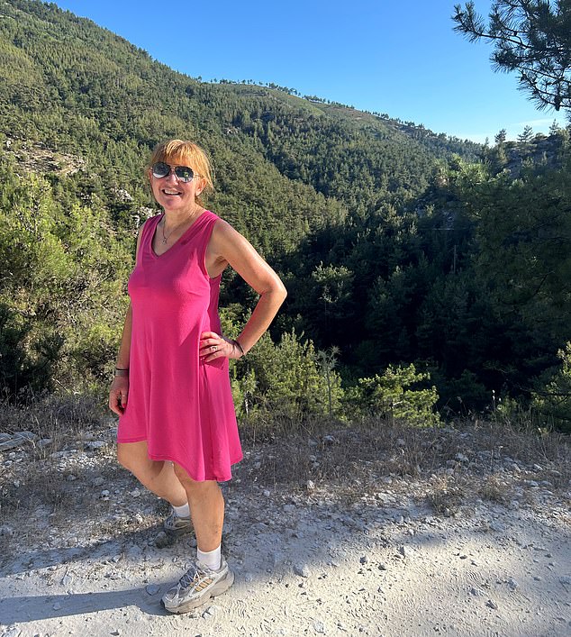 Angela poses in a pink dress during her vacation in the Greek countryside