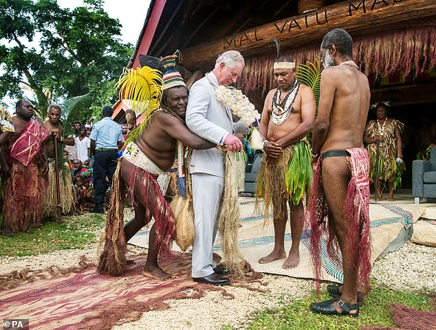 Charles is given a grass skirt to wear before being given a chieftaincy title during a visit to the Nakamal of the Chiefs during a visit to the island of Vanuatu in the South Pacific.