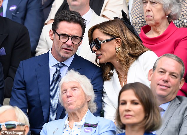 Jackman showed off his timeless elegance at the event, wearing a sleek navy designer suit paired with a white dress shirt and blue tie.