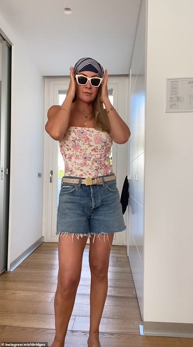 The author, who recently appeared on screens in I'm A Celebrity... Get Me Out Of Here! Australia, wore a relaxed look, wearing a pair of denim shorts over her swimsuit.