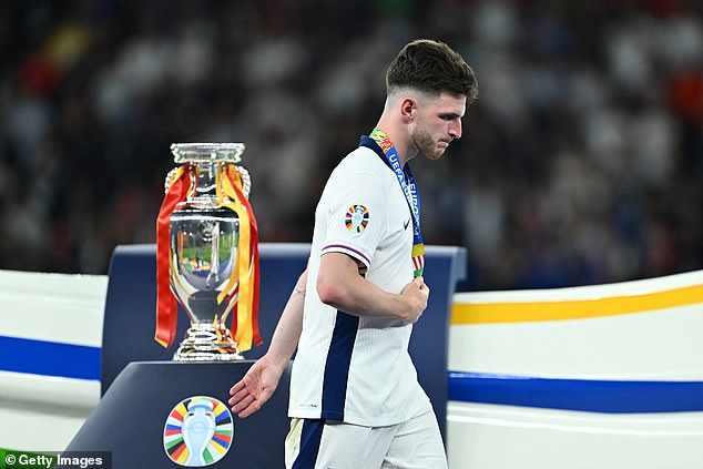 Rice was photographed walking past the trophy with a silver medal around his neck after Sunday's final.