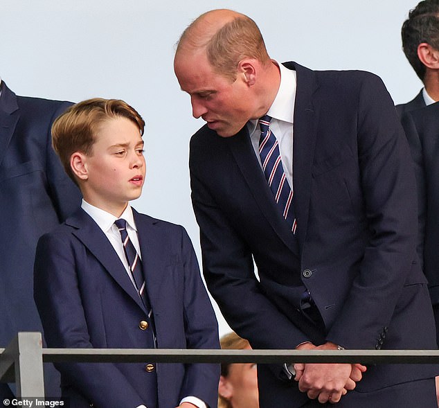 The father-son duo opted to wear matching navy suits, white shirts and similar striped ties at the match.