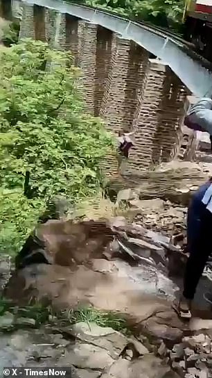 In a desperate attempt to avoid the oncoming train, the couple jumped off the bridge and fell into the gorge below.