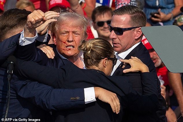 One of Crooks' bullets severed Donald Trump's ear at his rally in Butler, Pennsylvania. Secret Service helped him off the stage as the former president raised his fist and shouted 