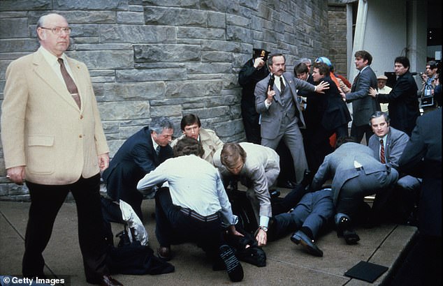 Reagan was saved by his top Secret Service agent, Tim McCarthy, who took a bullet for him, and by the medical staff at George Washington University Hospital. (Pictured: McCarthy and Press Secretary James Brady on the ground after being shot.)