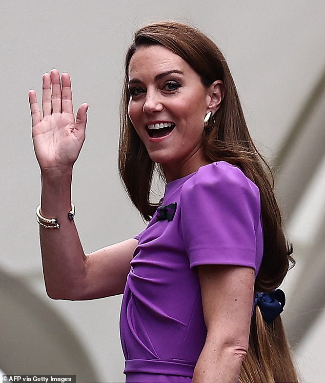 Catherine, Princess of Wales, waves as she arrives to attend the men's singles tennis final.