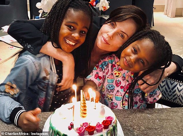 Here she is seen with her children during a birthday celebration.