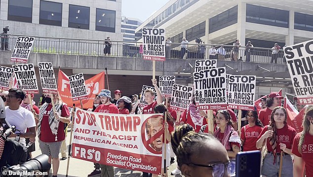 Organizers handed out signs to attendees reading 'Stop Trump and racist Republicans'