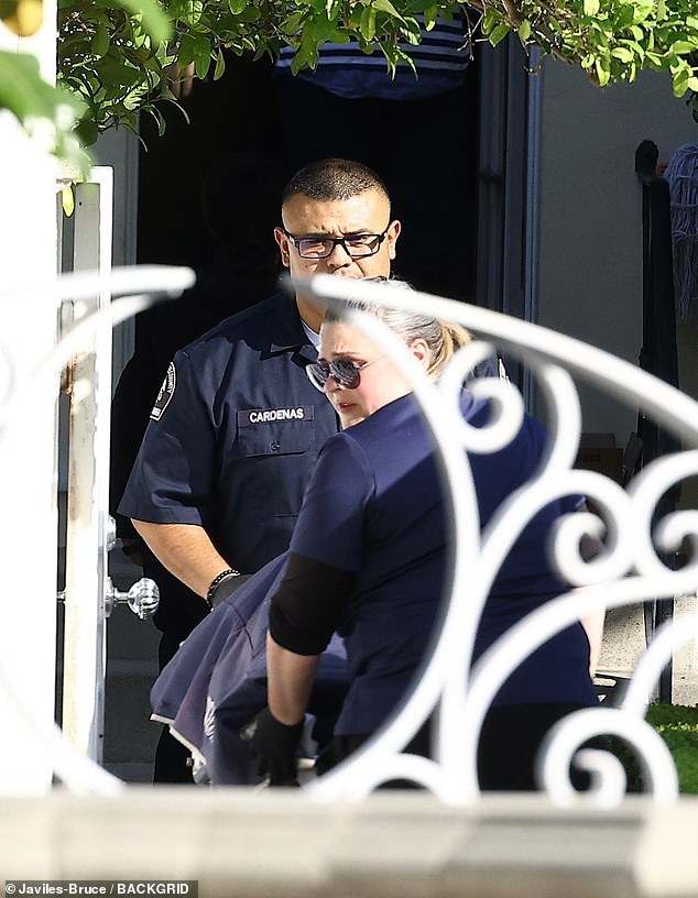 Images show Simmons' body being removed from his West Hollywood home on Saturday.