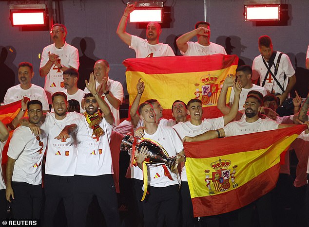 The Spanish players paraded through the streets and on stage with the iconic Henri Delaunay Trophy